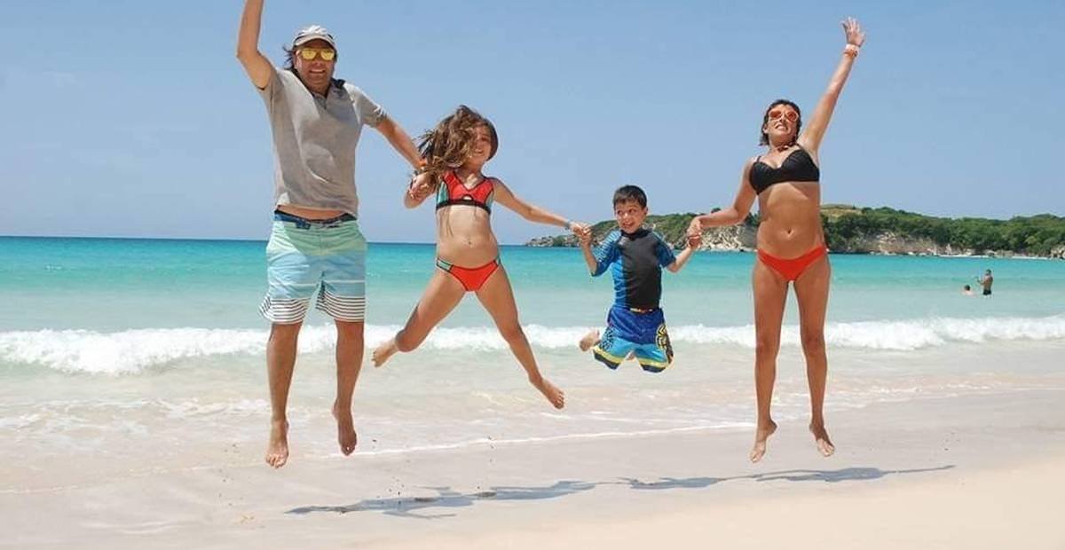 Family on a white sand beach in Punta Cana